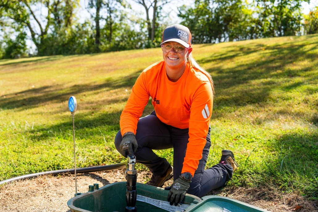 employee filling propane tank