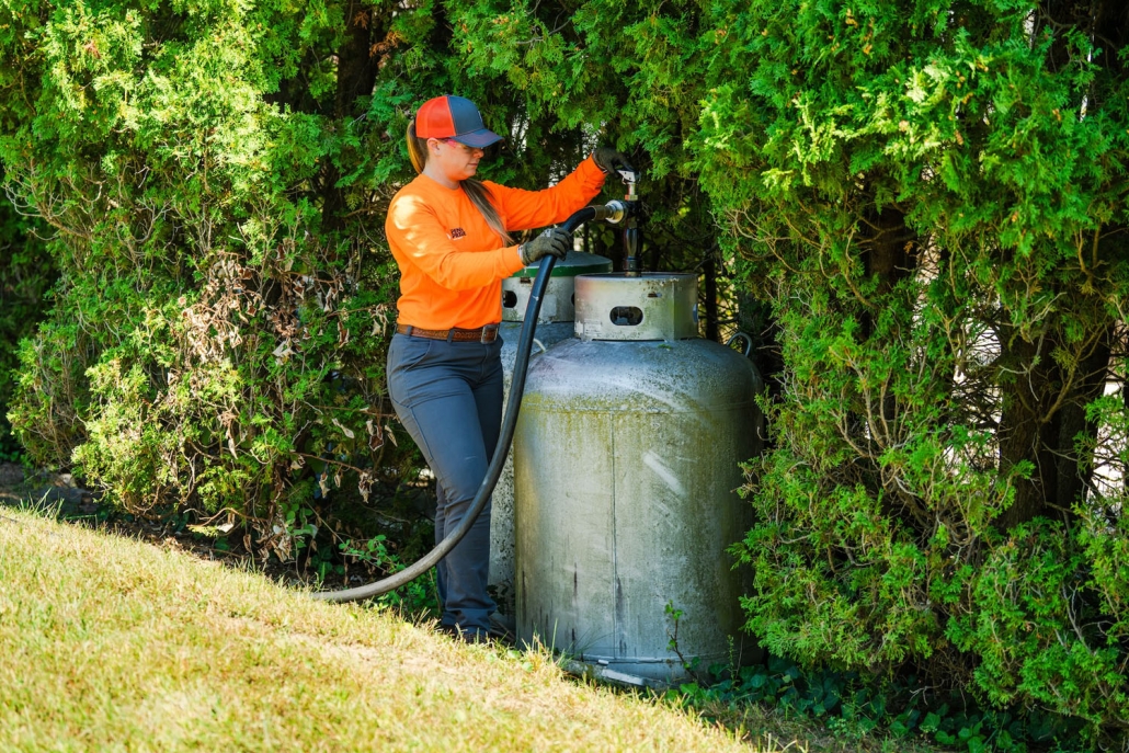 employee holding hose fueling tank