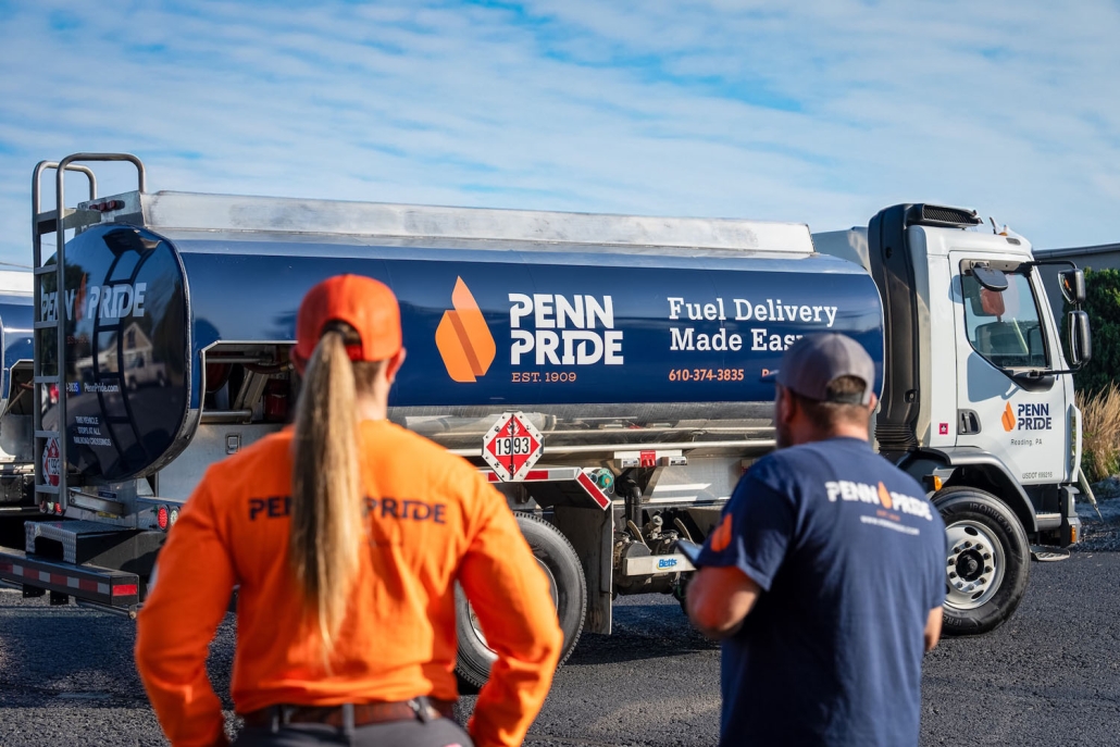 employees looking at fuel truck
