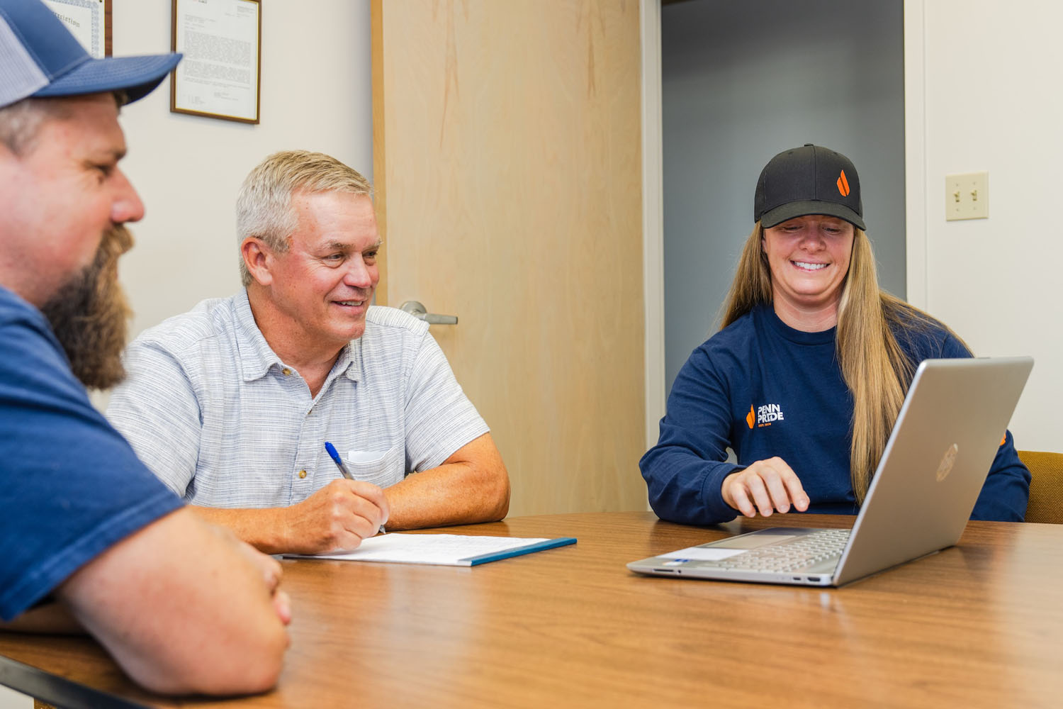 employees in an office looking at a computer
