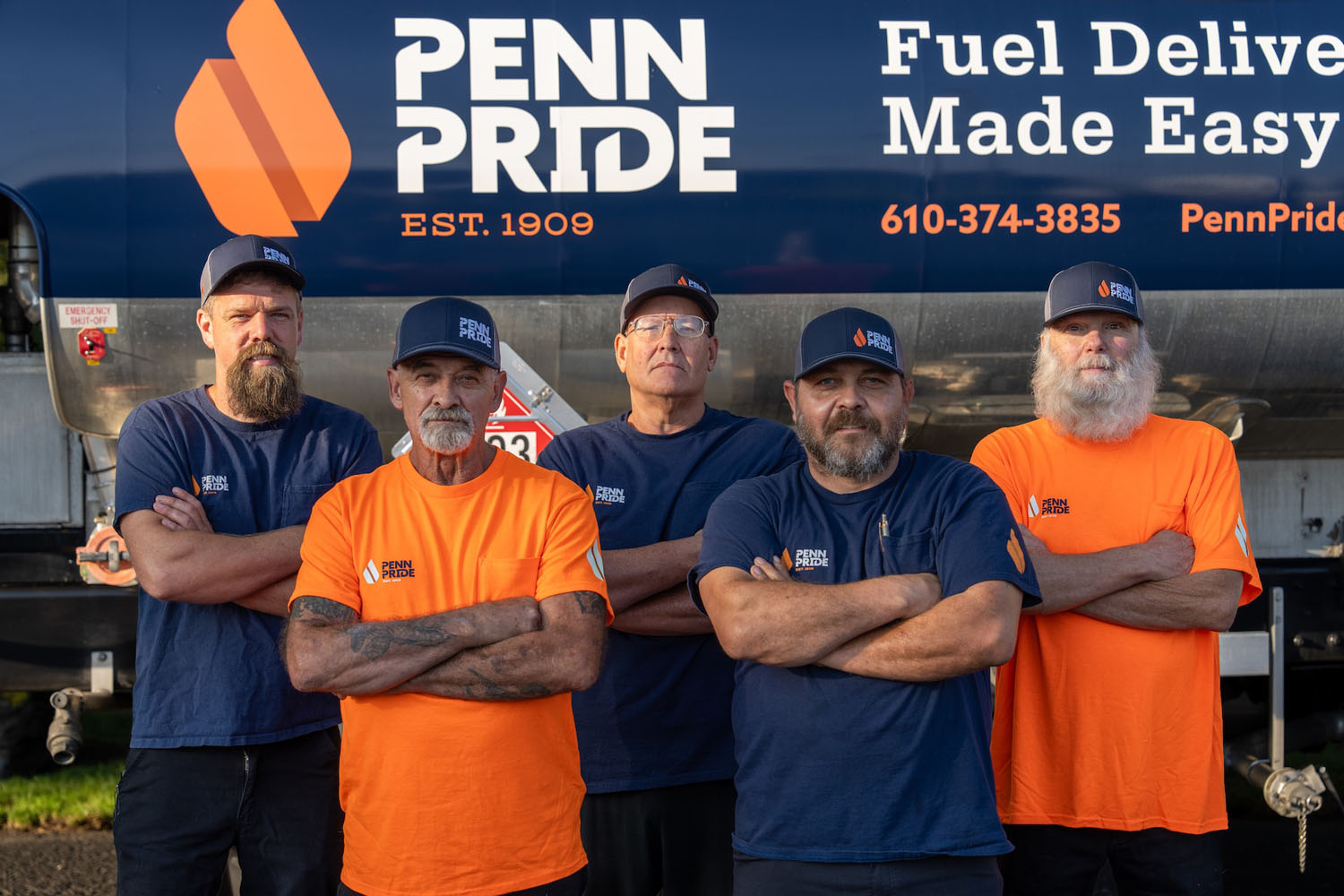 team of delivery drivers standing in front of a fuel truck